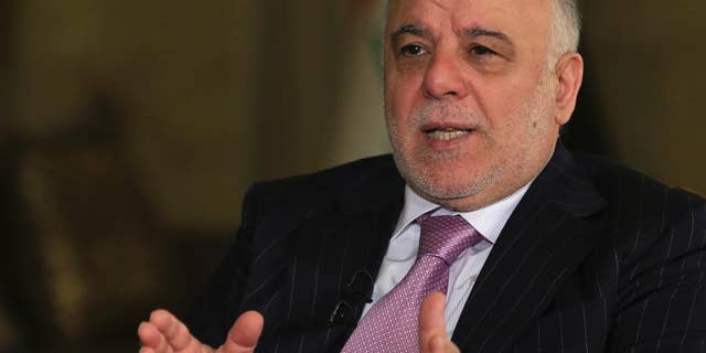 FILE - In this Monday, Nov. 28, 2016, file photo, Iraq's Prime Minister Haider al-Abadi speaks during an interview with the Associated Press in Baghdad. Iraq’s prime minister is demanding full disclosure about events surrounding the 2003 U.S.-led invasion of Iraq. Haider al-Abadi says he would like to see a “thorough investigation” of America’s decision-making that took the U.S. forces from “liberating” the country from “Saddam (Hussein’s) terrorist regime” to “occupying” Iraq. (AP Photo/Khalid Mohammed, File)