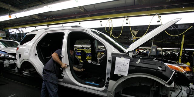 FILE - In this Dec. 1, 2010 file photo, plant employees assemble a 2011 Ford Explorer on the assembly line at Ford's Chicago Assembly Plant. Ford Motor Co. said Wednesday, May 22, 2013 that 21 of its North American factories will shut for only one week this summer. That includes the Chicago plant that makes the Ford Explorer SUV and the Mexican plant that makes the Fusion sedan.  (AP Photo/M. Spencer Green, File)