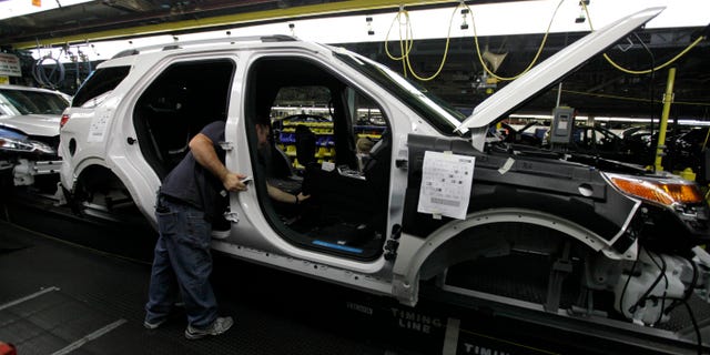 FILE - In this Dec. 1, 2010 file photo, plant employees assemble a 2011 Ford Explorer on the assembly line at Ford's Chicago Assembly Plant. Ford Motor Co. said Wednesday, May 22, 2013 that 21 of its North American factories will shut for only one week this summer. That includes the Chicago plant that makes the Ford Explorer SUV and the Mexican plant that makes the Fusion sedan. (AP Photo/M. Spencer Green, File)