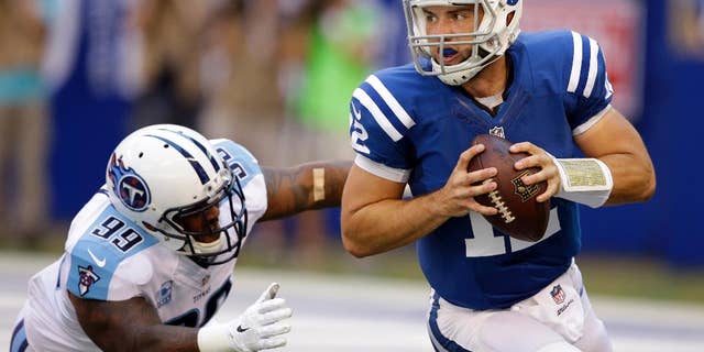 Tennessee Titans defensive end Jurrell Casey, left, chases Indianapolis Colts quarterback Andrew Luck during the first half of an NFL football game in Indianapolis, Sunday, Sept. 28, 2014. (AP Photo/Darron Cummings)