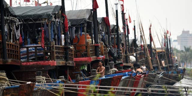 In this Oct. 3, 2015 photo provided by China's Xinhua News Agency, ships berth at Xingang harbor in Haikou, capital of south China's Hainan Province. Tens of thousands of people have been evacuated from coastal areas of southern China, with a strong typhoon that was moving toward the mainland on Sunday, Oct. 4, already bringing powerful winds and heavy rain to the region. Typhoon Mujigae was heading gradually toward the Leizhou Peninsula in Guangdong province, just north of the resort island of Hainan, according to the National Meteorological Center. (Zhao Yingquan/Xinhua News Agency via AP) NO SALES