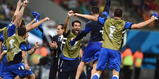 Italian goalie Gianluigi Buffon, face to camera, and coach Cesare Prandelli, center, celebrate with the team after the group D World Cup soccer match between England and Italy at the Arena da Amazonia in Manaus, Brazil, Saturday, June 14, 2014. Italy won the match 2-1. (AP Photo/Fabio Ferrari)