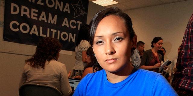 Erika Andiola poses for a portrait at a site where people line up to get guidance on Deferred Action.