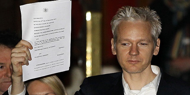 Dec. 16: WikiLeaks founder Julian Assange holds up a court document after he was released on bail in London.