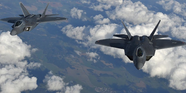Two U.S. F-22 Raptor fighters fly over European airspace during a flight to Britain from Mihail Kogalniceanu air base in Romania.