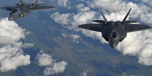 Two U.S. F-22 Raptor fighters fly over European airspace during a flight to Britain from Mihail Kogalniceanu air base in Romania.