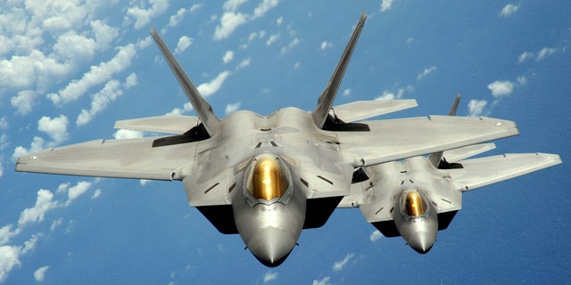 Two U.S. Air Force F-22 Raptor stealth jet fighters fly near Andersen Air Force Base in this handout photo dated August 4, 2010. (REUTERS/U.S. Air Force/Master Sgt. Kevin J. Gruenwald/Handout)