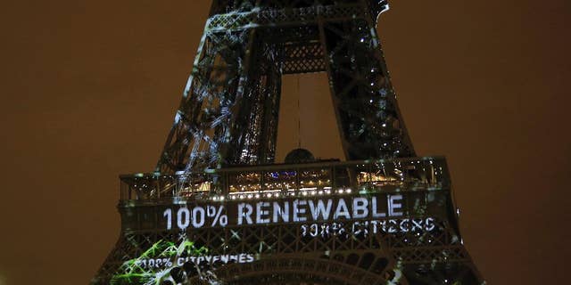 FILE- In this Sunday, Nov. 29, 2015 file photo, an artwork entitled 'One Heart One Tree' by artist Naziha Mestaoui is displayed on the Eiffel tower ahead of the 2015 Paris Climate Conference, in Paris. The Paris Agreement on climate change comes into force Friday Nov. 4, 2016, after a year with remarkable success in international efforts to slash man-made emissions of carbon dioxide and other global warming gases. (AP Photo/Thibault Camus, FILE)