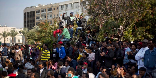 African migrants protest in Rabin's square in Tel Aviv, Israel, Sunday, Jan. 5, 2014. Police spokesman Micky Rosenfeld said about 10,000 migrants marched through Tel Aviv Sunday. Protestors said they are on a three-day strike to protest a crackdown on migrants that can lead to incarceration in a newly built detention facility. (AP Photo/Ariel Schalit)