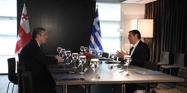 Greece's Prime Minister Alexis Tsipras, right, speaks with his Georgian Giorgi Kvirikashvili during their meeting in the northern Greek city of Thessaloniki, Tuesday, May 17, 2016. Tsipras and Kvirikashvili with other officials from Turkey, Bulgaria, Azerbaijan and Italy will participate in a ceremony of launch of the construction of Trans Adriatic Pipeline (TAP). (AP Photo/Giannis Papanikos)
