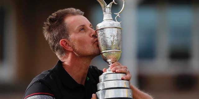 Henrik Stenson of Sweden kisses the trophy after winning the British Open Golf Championships at the Royal Troon Golf Club in Troon, Scotland, Sunday, July 17, 2016. (AP Photo/Ben Curtis)