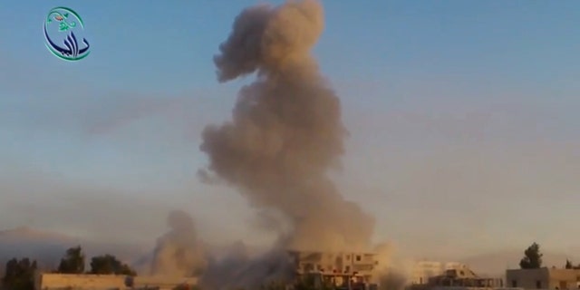 In this image taken from video obtained from the Shaam News Network, which has been authenticated based on its contents and other AP reporting, smoke billows amid buildings at a bomb explosion in Daraya, a countryside of Damscus, Syria, Tuesday, Oct. 15, 2013. Syrian warplanes bombed several rebel-held areas Tuesday and opposition fighters fired mortar rounds and homemade rockets at Damascus on the first day of a major Muslim holiday, activists said. (AP Photo/Shaam News Network via AP Video)