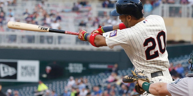 Minnesota Twins' Eddie Rosario hits his first major league home run on the first pitch off Oakland Athletics pitcher Scott Kazmir in the third inning of a baseball game, Wednesday, May 6, 2015, in Minneapolis. (AP Photo/Jim Mone)