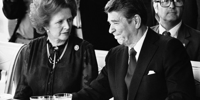 President Ronald Reagan and British Prime Minister Margaret Thatcher at the lunch table, Sunday, June 6, 1982, at the Palace of Versailles, France, following the first session of the second day's summit meeting. 