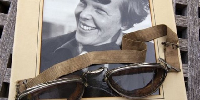 Sept. 9, 2011: An original, unpublished personal photo of Amelia Earhart dated 1937, along with goggles she was wearing during her first plane crash are seen at Clars Auction Gallery in Oakland, Calif. Another set of her goggles sold several years ago for more than $100,000.