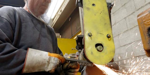 In this photo made on Thursday, Feb. 12, 2015, a workers grinds parts used to build fans for industrial ventilation systems at the Robinson Fans Inc. plant in Harmony, Pa. The Institute for Supply Management, a trade group of purchasing managers, issues its index of manufacturing activity for April on Friday, May 1, 2015. (AP Photo/Keith Srakocic)