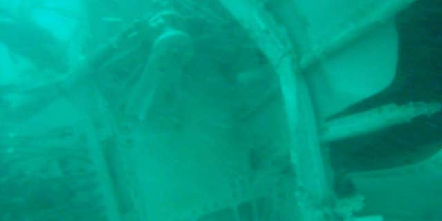 FILE - In this undated underwater file photo released by Indonesia's National Search And Rescue Agency (BASARNAS) on Wednesday, Jan. 7, 2015, the part of the wreckage that BASARNAS identified as of the ill-fated AirAsia Flight 8501, is seen in the waters of the Java Sea, Indonesia. The second attempt to lift the fuselage of the crashed AirAsia jetliner failed Sunday, Jan. 25, 2015 as the wreckage sank back to the ocean floor when a rope linking the lifting balloons broke. Navy spokesman Manahan Simorangkir said strong current was the main obstacle. The rope had been fastened and linked to a ship, but broke again as the fuselage was lifted. (AP Photo/BASARNAS, File)
