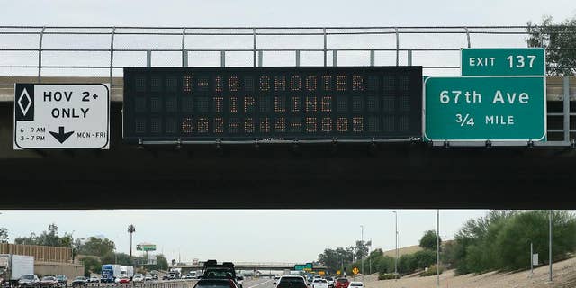 A tip line for motorist is seen on a freeway sign along I-10, Thursday, Sept. 10, 2015 in Phoenix. Numerous shootings of vehicles along I-10 over the past two weeks have investigators working around the clock to find a suspect in a spate of recent Phoenix freeway shootings that have rattled nerves and heightened fears of a possible serial shooter. (AP Photo/Matt York)
