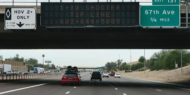 A tip line for motorist is seen on a freeway sign along I-10, Thursday, Sept. 10, 2015 in Phoenix. Numerous shootings of vehicles along I-10 over the past two weeks have investigators working around the clock to find a suspect in a spate of recent Phoenix freeway shootings that have rattled nerves and heightened fears of a possible serial shooter. (AP Photo/Matt York)