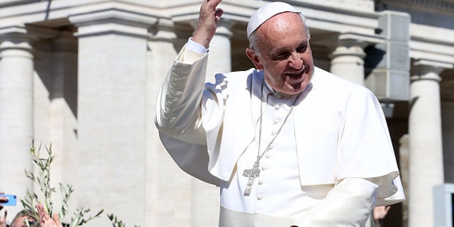 VATICAN CITY, VATICAN - MARCH 29: Pope Francis waves to the faithful as he leaves St. Peter's Square at the the end of Palm Sunday Mass on March 29, 2015 in Vatican City, Vatican. On Palm Sunday Christians celebrate Jesus' arrival into Jerusalem, where he was put to death. It marks the official beginning of Holy Week during which Christians observe the death of Christ before celebrations begin on Easter. (Photo by Franco Origlia/Getty Images)