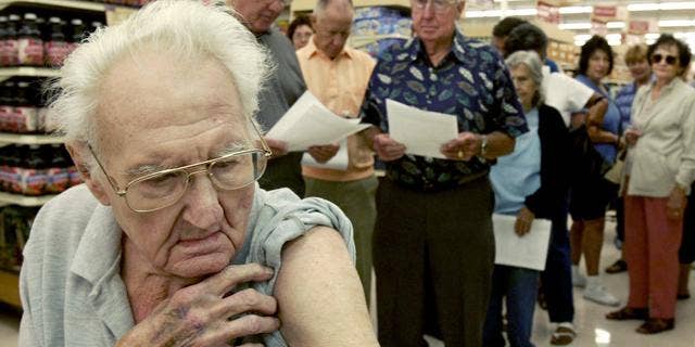 Pete Jacksen, 86, waits in line to get a flu shot at Pavilions pharmacy in Monrovia, Calif., Thursday, Oct. 7, 2004. Health officials nationwide are urging healthy adults and schoolchildren to skip the shot because British regulators have shut down the major flu-shot supplier Chiron on Tuesday, citing manufacturing problems.(AP Photo/Nick Ut)