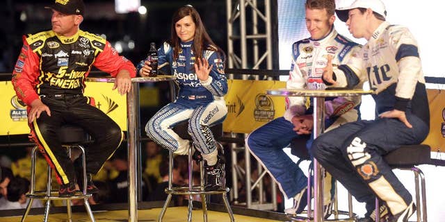 Clint Bowyer, Danica Patrick, AJ Allmendinger and Brad Keselowski, from right, watch during driver introductions prior to the NASCAR Sprint All-Star auto race at Charlotte Motor Speedway in Concord, N.C., Saturday, May 16, 2015. (AP Photo/Gerry Broome)