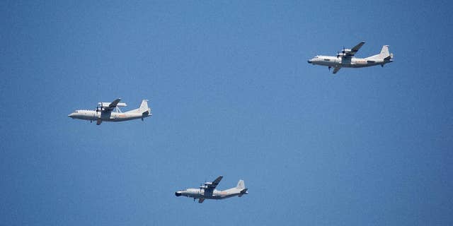 FILE - In this Sept. 3, 2015 file photo, a KJ-200 airborne early warning and control plane, left, a Y-8J radar plane, center, and a Y-9JB radar plane, right, fly in formation during a parade commemorating the 70th anniversary of Japan's surrender during World War II in Beijing. The U.S. Pacific Command says a Chinese aircraft and a U.S. Navy patrol plane had an "unsafe" encounter over the South China Sea this week, raising concerns. Pacific Command spokesman Robert Shuford said Friday, Feb. 10, 2017, that the "interaction" between a Chinese KJ-200 early warning aircraft and a U.S. Navy P-3C plane took place on Wednesday, Feb. 8, in international airspace over the waters. (AP Photo/Mark Schiefelbein, File)