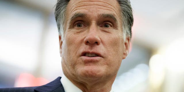 FILE - In this Tuesday, Nov. 29, 2016 file photo, former Republican presidential nominee Mitt Romney talks with reporters in New York. Former Democratic Vice President Joe Biden is encouraging former Republican presidential candidate Mitt Romney to run for a senate seat in Utah currently held by Orrin Hatch if the senator decides to retire next year. Biden made the comment to Romney Friday, June 9, 2017 at a luxury resort in Utah, where Romney was hosting an annual invitation-only business and politics summit.. (AP Photo/Evan Vucci, File)