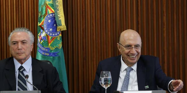 Brazil's acting President Michel Temer, left, presides over his first cabinet meeting, at the Planalto presidential palace in Brasilia, Brazil, Friday, May 13, 2016.  Newly named Finance Minister Henrique Meirelles is pictured at right. (AP Photo/Eraldo Peres)