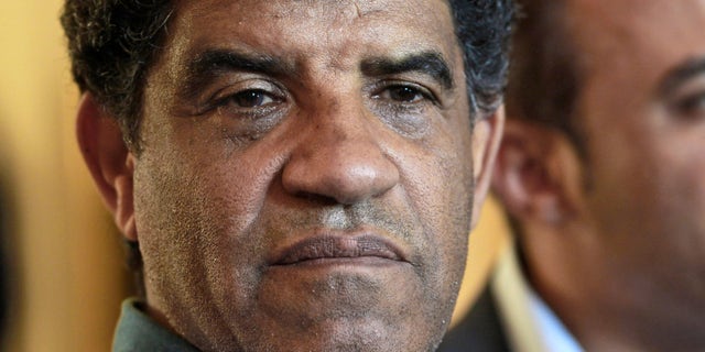 FILE - In this Sunday, Aug. 21, 2011 file photo Abdullah al-Senoussi, head of Libyan intelligence, speaks to the press in Tripoli, Libya. In a surprise decision, judges at the International Criminal Court (ICC) ruled Friday, Sept. 11, 2013, one of the most prominent members of slain dictator Moammar Gadhafiís regime should be tried for war crimes at home, essentially saying they think Libyaís legal system is fair and functional enough to handle a complex trial. The pretrial chamber at the Hague, Netherlands-based court said in its ruling Libyan authorities are ìwilling and ableî to prosecute former intelligence chief Abdullah al-Senoussi, and therefore he cannot be tried at the ICC. Al-Senoussi is accused of alleged crimes against humanity for the murder and persecution of protesters in the early days of the uprising that eventually toppled Gadhafi in 2011. (AP Photo/Dario Lopez-Mills, File)