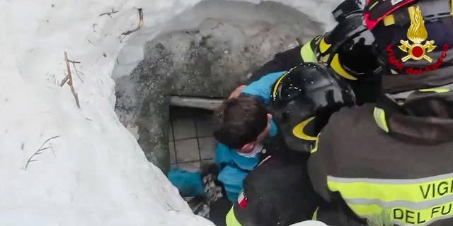 This frame from video shows Italian firefighters extracting a boy alive from under snow and debris of an hotel that was hit by an avalanche on Wednesday, in Rigopiano, central Italy, Friday, Jan. 20, 2017. (Italian Firefighters/ANSA via AP)