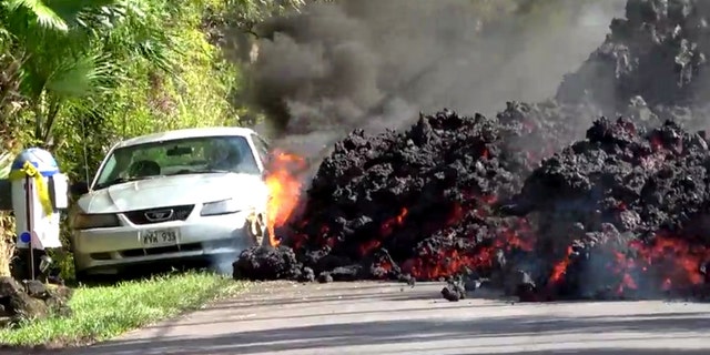 Lava engulfs a Ford Mustang in Puna, Hawaii, U.S., May 6, 2018 in this still image obtained from social media video.