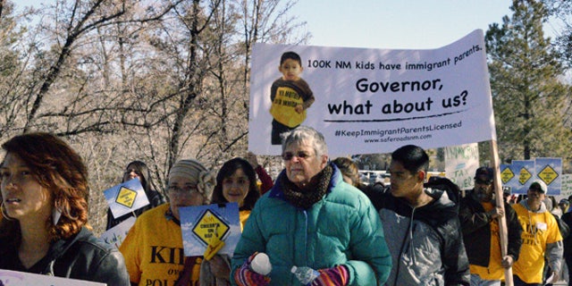 Immigrant advocates protest on Monday, Feb. 2, 2015, in Santa Fe, N.M.