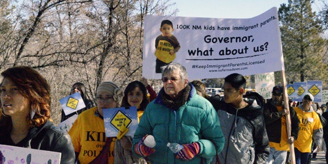 Immigrant advocates protest on Monday, Feb. 2, 2015, in Santa Fe, N.M.