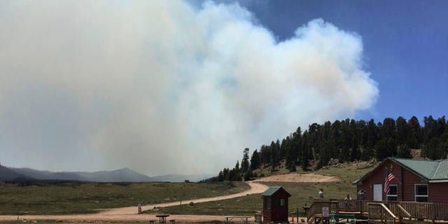 This photo provided by the National Park Service ranger Rachel Post shows a smoke plume from a wildfire in the Valles Caldera National Preserve, north of Jemez Springs, N.M., Thursday, June 15, 2017. The wildfire burning in northern New Mexico prompted the evacuation Thursday of residents and led the governor to activate the state emergency operations center. (Rachel Post/NPS via AP)