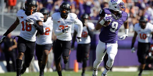 Oklahoma State cornerback Ramon Richards (18) and others give chase after TCU's Josh Doctson (9) after Doctson grabbed a pass and sprinted to the end zone for a score in the first half of an NCAA college football game, Saturday, Oct. 18, 2014, in Fort Worth, Texas. (AP Photo/Tony Gutierrez)