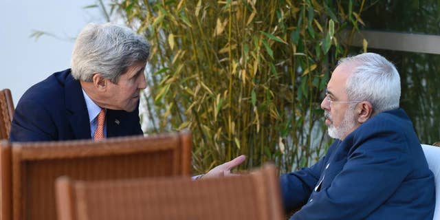 FILE --  May 30, 2015: Secretary of State John Kerry, left, talks with Iranian Foreign Minister Mohammad Javad Zarif, in Geneva, Switzerland.