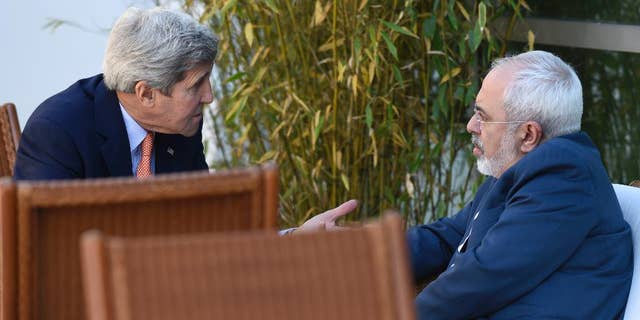 FILE -- May 30, 2015: Secretary of State John Kerry, left, talks with Iranian Foreign Minister Mohammad Javad Zarif, in Geneva, Switzerland.