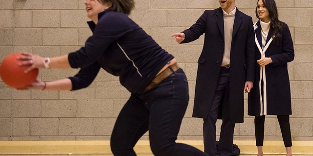 Britain's Prince Harry and his fiancee Meghan Markle watch Coach Core apprentices taking part in a training masterclass exercise during their to visit the Nechells Wellbeing Center in Birmingham, England, on March 8, 2018.