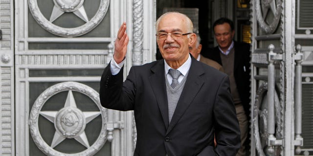 April 16: Syrian opposition member Hassan Abdul-Azim waves to press as he walks out of the Russian Foreign Ministry in Moscow after talks.