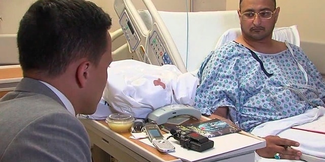 FILE - In this June 29, 2016 file still image from video, Ahmed al-Menhali, right, is interviewed by WEWS at St. John Medical Center after he collapsed following an encounter with police in Avon, Ohio. A prosecutor continues to investigate the detention by police at gunpoint of the businessman from the United Arab Emirates at a northeast Ohio hotel, after a hotel clerk raised suspicions that he could have links to terrorism. (WEWS via AP, File)