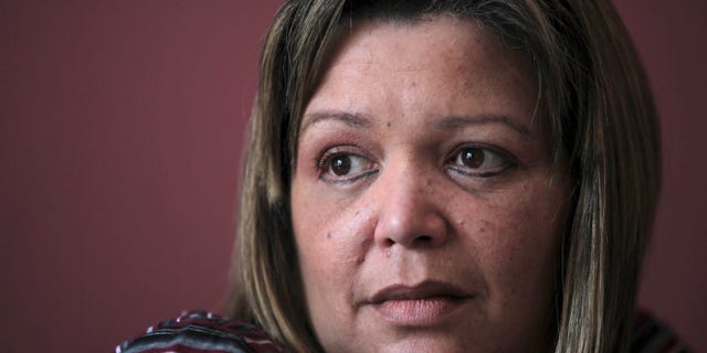 FILE - In this Oct. 31, 2011 file photo, Venezuelan Judge Maria Lourdes Afiuni sits in her apartment while under house arrest in Caracas, Venezuela. Human rights officials from the United Nations are calling on Venezuela's government to free a judge who has been charged with corruption, abuse of authority and aiding an inmate's escape. Margaret Sekaggya is the U.N.'s special rapporteur on the situation of human rights defenders and she joined other U.N. officials on Thursday, Feb. 14, 2013 in urging freedom for Maria Lourdes Afiuni. The judge maintains she is innocent. Afiuni infuriated President Hugo Chavez in 2009 when she freed a banker from prison while he was awaiting trial on charges of flouting currency exchange controls. A day after Afiuni's arrest, Chavez said she should face a 30-year-prison sentence. (AP Photo/Fernando Llano, File)