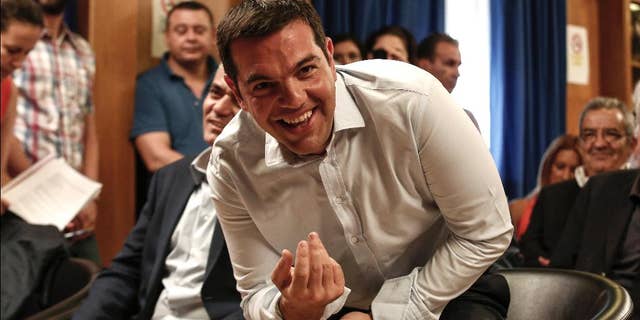 Greece's Prime minister Alexis Tsipras takes his seat to attend a gathering at the Agriculture ministry in Athens, Greece, on Wednesday, Aug. 5, 2015. Tsipras said his country was at the “final stage” of talks for a new bailout, as his left-wing government on Wednesday rejected the idea of an extension in negotiations. (AP Photo/Yorgos Karahalis)