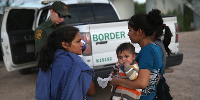 MCALLEN, TX - SEPTEMBER 08:  Families of Central American immigrants turn themselves in to U.S. Border Patrol agents after crossing the Rio Grande River from Mexico on September 8, 2014 to McAllen, Texas. Although the numbers of such immigrant families and unaccompanied minors have decreased from a springtime high, thousands continue to cross in the border illegally into the United States. The Rio Grande Valley sector is the busiest area for illegal border crossings, especially for Central Americans, into the U.S.  (Photo by John Moore/Getty Images)