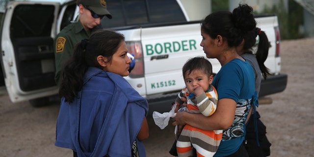 MCALLEN, TX - SEPTEMBER 08: Families of Central American immigrants turn themselves in to U.S. Border Patrol agents after crossing the Rio Grande River from Mexico on September 8, 2014 to McAllen, Texas. Although the numbers of such immigrant families and unaccompanied minors have decreased from a springtime high, thousands continue to cross in the border illegally into the United States. The Rio Grande Valley sector is the busiest area for illegal border crossings, especially for Central Americans, into the U.S. (Photo by John Moore/Getty Images)