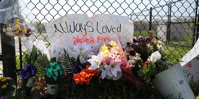 A makeshift memorial stands outside a park, where bodies of four men were found on April 13, in Central Islip, New York, U.S., April 28