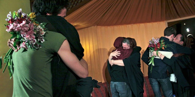 May 20: The mothers of 3 Americans detained in Iran hug their children at the Esteghlal hotel in Tehran.