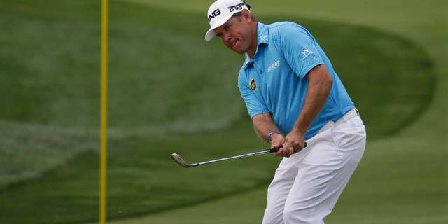 Lee Westwood, of England, hits a chip on the first hole during the first round of the PGA Championship golf tournament at Valhalla Golf Club on Thursday, Aug. 7, 2014, in Louisville, Ky. (AP Photo/David J. Phillip)