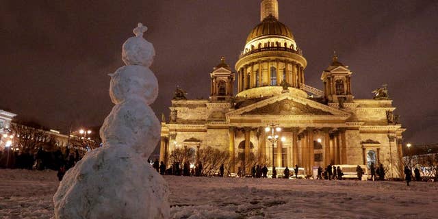 A snowman stands in front of the St. Isaac's Cathedral in St.Petersburg, Russia, Friday, Jan. 13, 2017. In the latest scandal involving the powerful Russian Orthodox Church, authorities in St. Petersburg on Thursday defended a controversial decision to give a city landmark cathedral to the church. (AP Photo/Dmitri Lovetsky)
