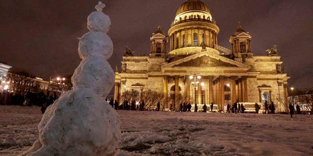 A snowman stands in front of the St. Isaac's Cathedral in St.Petersburg, Russia, Friday, Jan. 13, 2017. In the latest scandal involving the powerful Russian Orthodox Church, authorities in St. Petersburg on Thursday defended a controversial decision to give a city landmark cathedral to the church. (AP Photo/Dmitri Lovetsky)